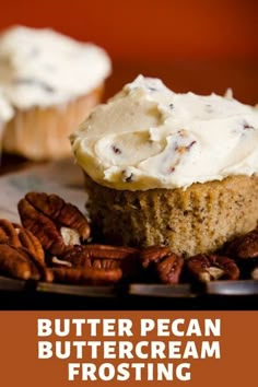 a close up of a cupcake with frosting and pecans on a plate