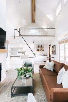 a living room filled with furniture and a flat screen tv