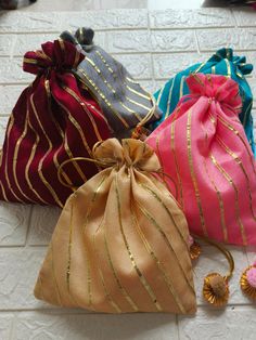 Product Item:Both Side Full Gota Potli Bags With Tassels Material: Brocade Fabric ,Gota Patti. Size:-7 x 5 Inches Approx. Color- Assorted Color will be send ( Color can be customize) Details - Potli Bag: Exquisite potli bag adorned with golden touch, adding a touch of elegance and charm to any outfit. Wedding Favors: Perfect for weddings, Haldi , Mehndi these potli bags can be delightful favors for guests, offering a blend of tradition and style. The extravagant style of Gujarat comes to life th Potli Bag, Bridal Purse, Return Gifts, Outfit Wedding, Potli Bags, Diwali Gifts, Design Clothes, Women Handbag, Indian Outfit