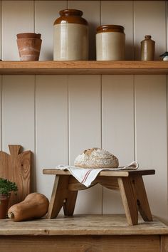 a wooden table topped with a loaf of bread