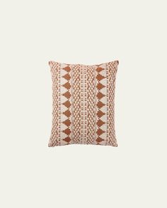 a brown and white pillow on a white background