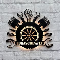 a sign that says lukschewitz with tools and wrenches on it