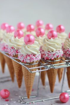 some ice cream cones with pink sprinkles on them