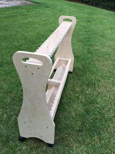 two wooden benches sitting on top of a lush green field