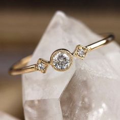 a diamond ring sitting on top of a rock