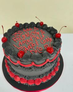 a black and red cake with writing on it