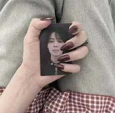 a woman's hand holding a card with a photo on it