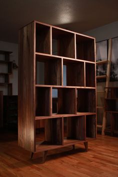 a wooden bookcase sitting on top of a hard wood floor