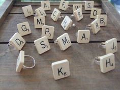 the letters are spelled with white blocks and silver rings on top of a wooden table