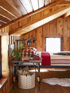 a bedroom with wood paneling and wooden floors