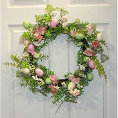 an easter wreath is hanging on the front door