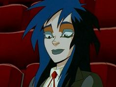 an anime character with blue hair in front of rows of red seats, staring at the camera