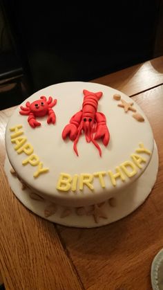 a birthday cake with two crabs on it