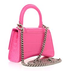 This is an authentic BALENCIAGA Shiny Calfskin Crocodile Embossed Hourglass Top Handle Bag Mini with Chain in Neon Pink. This stylish and structured handbag is crafted of crocodile embossed pink calfskin leather. The bag features a sturdy leather top handle with gray metal links and a prominent B logo on the front flap, and an optional, adjustable shoulder strap. The front flap opens with a magnetic snap closure to a smooth pink leather compact interior. Balenciaga Hourglass Bag, Pink Balenciaga, B Logo, Everyday Tote, Balenciaga Bag, Mini Purse, Chain Shoulder Bag, Handle Bag, Pink Leather