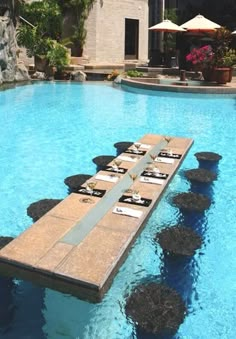 an outdoor swimming pool with stepping stones in the water