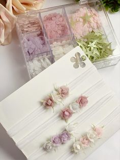 flowers are placed on the table next to some paper napkins and other items in plastic containers