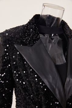 Expertly crafted with a PU Leather lapel and sequin embellishments, our Midnight Dream blazer exudes sophistication and style. The included up leather belt adds a touch of elegance, making this blazer perfect for any special occasion. Elevate your wardrobe with this must-have statement piece. Decoration Sequined Style Elegant Fabric Type Blended fabrics , Sequin , PU Material Polyester , Polyester Neckline Suit Collar Pattern Type Solid , Patchwork Sleeve Length Full Season Spring / Autumn , Winter Fabric Slight Stretch Fall Party Outerwear With Suit Collar, Chic Party Outerwear With Suit Collar, Chic Outerwear With Suit Collar For Party, Chic Suit Collar Blazer For Party, Black Holiday Evening Blazer, Fitted Blazer With Contrast Sequin For Fall, Glamorous Fall Office Blazer, Tailored Embellished Blazer For Office, Luxury Evening Blazer For Fall