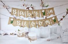 a burlly bunting banner with flowers on it next to a vase and cake