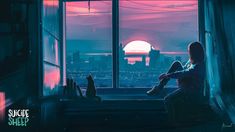 a person sitting on a window sill looking out at the city skyline and sunset