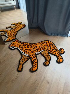 two cheetah shaped rugs sitting on the floor