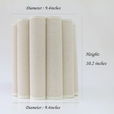 four tall cylindrical lamps are shown with measurements