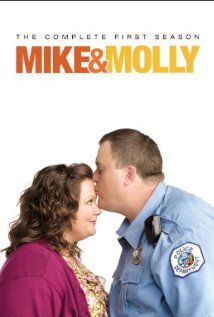 a man and woman kissing each other in front of a poster for mike & dolly