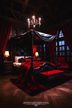 a canopy bed with red velvet sheets and chandelier hanging from the ceiling in a dark bedroom