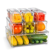 a stack of plastic containers filled with different types of fruits and vegetables on top of each other