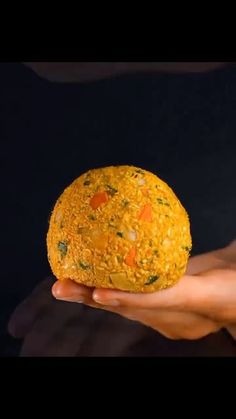 a person holding a ball of food in their hand