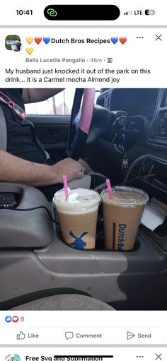 two cups of coffee sitting in the passenger seat of a car with pink straws sticking out of them