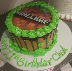 a birthday cake with green frosting and an image of a minecraft logo on it