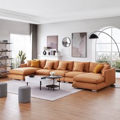 a living room filled with lots of furniture next to a large window covered in windows