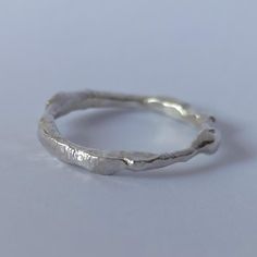 This sterling silver ring, handmade with recast 925 silver and a shiny finish, is a unique jewel that captures the essence of authentic craftsmanship. Ideal if you want an original and different jewel. Perfect for those who value beauty in its most natural and sustainable form, this ring is not just a piece of jewelry, it is a statement of conscious elegance. Make it yours and carry with you a shine that will last! Inner diameter 12.5mm, circumference 53mm, US size 6 1/2 Sterling Silver Jewelry With Unique Texture, Silver Sterling Jewelry With Unique Texture, Minimalist Silver Engraved Ring With Hammered Detail, Minimalist Silver Hammered Engraved Ring, Minimalist Hammered Silver Engraved Ring, Minimalist Silver Engraved Ring Hand Forged, Minimalist Silver Hand Forged Engraved Ring, Minimalist Hand Forged Silver Engraved Ring, Minimalist Silver Engraved Hand-cast Ring