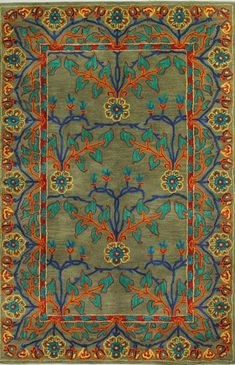 a green rug with blue, orange and red designs on the bottom half of it