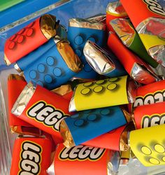 many different types of candy are in a plastic bag with the word lego written on it