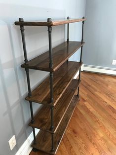 a wooden shelf sitting on top of a hard wood floor