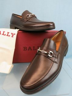 BALLY "CADORE" CHOCOLATE CALF LEATHER SILVER METAL BIT "B" LOGO LOAFERS    BY BALLY 100% AUTHENTIC,GUARANTEED!!! Color: Chocolate (Printed on The Box)  Leather Upper Silver Tone Metal Bit " B" Logo  on the vamp Round Toe Leather lining "BALLY" Letterin stamped Logo At Both sides Rubber "BALLY" stamped logo Sole "BALLY" stamped logo  leather insole 3/4" Block heel MEN'S Size EU 9.5 E / US 10.5 D / FR 43.5-print on the box Original Price : $ 595 NOTE!!!  These shoes came from a famous store !!! They are new but they are in-store item and it’s possible that somebody tried them on inside the store. That could cause tiny exterior imperfections or marks on outsoles that are invisible when you wear them. They are new, in great condition, but we are stating them as a “new in box - store item”. NOT Designer Brown Moccasins For Galas, B Logo, Chocolate Leather, Box Store, Color Chocolate, Leather Silver, The Vamps, Mens Casual Shoes, Loafers Men