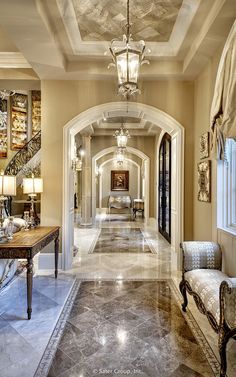 an image of a long hallway with chandeliers on the ceiling and marble floors