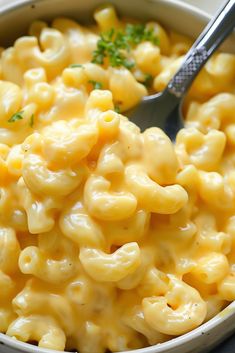 a bowl filled with macaroni and cheese on top of a table