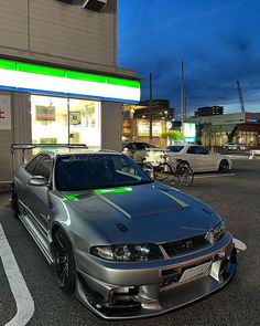 a silver car parked in front of a gas station