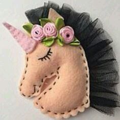 a felt unicorn head with flowers on it