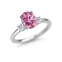 a pink diamond ring with three diamonds on the band and an oval cut stone in the center