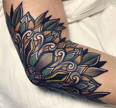 a woman's leg with an artistic tattoo design on it, and the bottom part of her arm