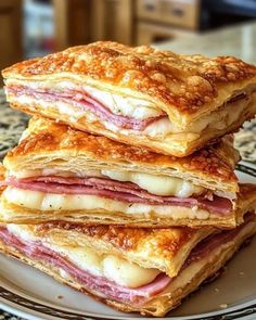 three sandwiches stacked on top of each other on a plate