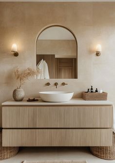 a bathroom with a sink, mirror and rug