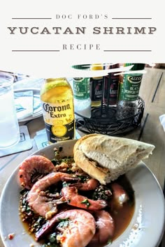 a white plate topped with shrimp and bread