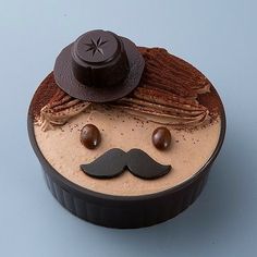 a cupcake with chocolate frosting and a mustache on it's face is shown