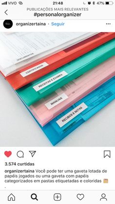 three different colored file folders stacked on top of each other with labels attached to them