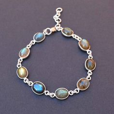 Oval Labradorite Crystal And 925 Sterling Silver Handmade Bracelet, Natural Gemstone And Solid Silver Jewelry, Hypoallergenic And Tarnish Free, Lightweight And Comfortable Metal : 925 Sterling silver  Gemstone : Natural Labradorite Ideal For: Men, Women, boys, Girls  World Wide Free Shipping. Shipping Services -USPS, UPS, DPD, and ECOM. Order Below 150 USD Will Ship Through USPS. (8 To 25 Working Days Delivery) It depends on your country customs clearance. Processing Time-  Your order will be ha Blue Labradorite Bracelet, Silver Labradorite Bracelets With Round Beads, Silver Labradorite Gemstone Bead Bracelets, Silver Labradorite Bracelets With Gemstone Beads, Silver Labradorite Bracelet With Gemstone Beads, Silver Labradorite Bracelets, Silver Bracelets With Natural Stones And Labradorite, Silver Labradorite Bracelets With Natural Stones, Labradorite Bracelets With Natural Stones