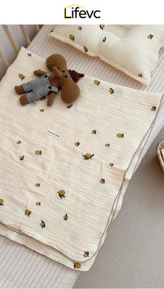 a baby bed with a teddy bear on it